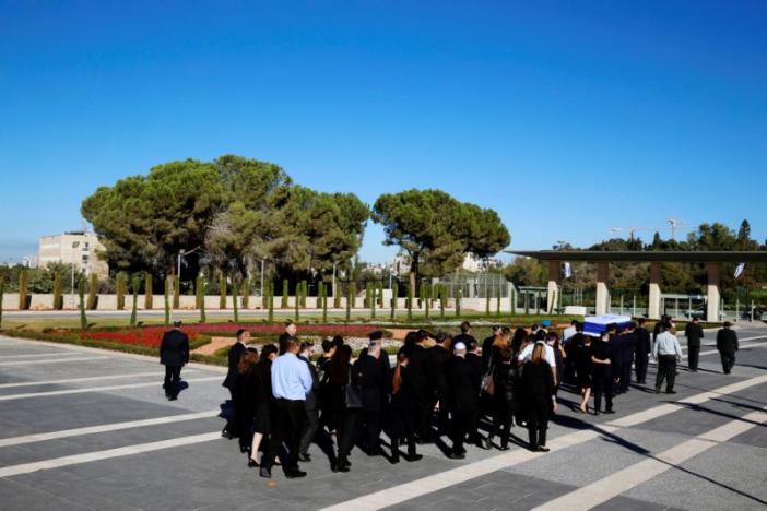 Family members of former Israeli President Shimon Peres walk behind his flag-draped coffin during a ceremony at the Knesset, the Israeli parliament, before it is transported to Mount Herzl Cemetery ahead of the funeral in Jerusalem