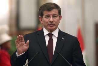 Turkey's Prime Minister Ahmet Davutoglu speaks at a news conference with Iraqi Prime Minister Haider al-Abadi (not pictured) in Baghdad, November 20, 2014. REUTERS/Hadi Mizban/Pool (IRAQ - Tags: POLITICS)